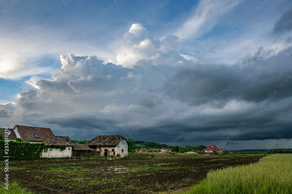 A menacing looking storm above the green fields of the Mures Valley, Romania.