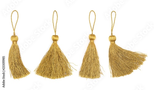 Golden silk tassels isolated on white background for creating graphic concepts photo
