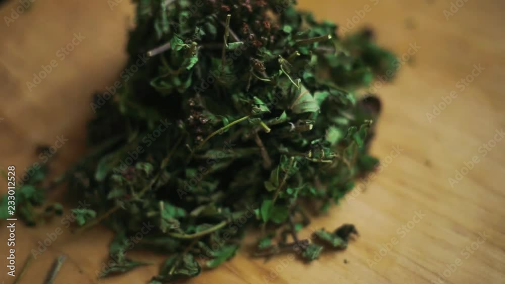 Dried herbs are spinning on a wooden grass. Tea from medicinal dried herbs. The raw material for a medicinal tea. Grass thyme Dried herbs are spinning on a wooden grass. Tea from medicinal dried herbs. The raw material for a medicinal tea. Grass thyme