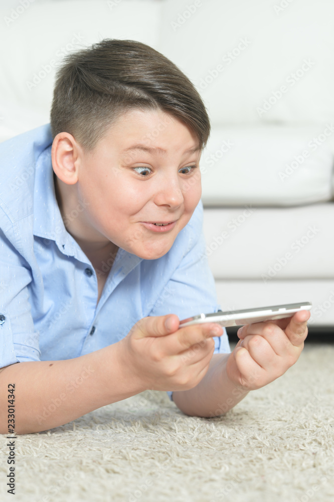 Portrait of young boy with smartphone at home Portrait of young boy with smartphone at home