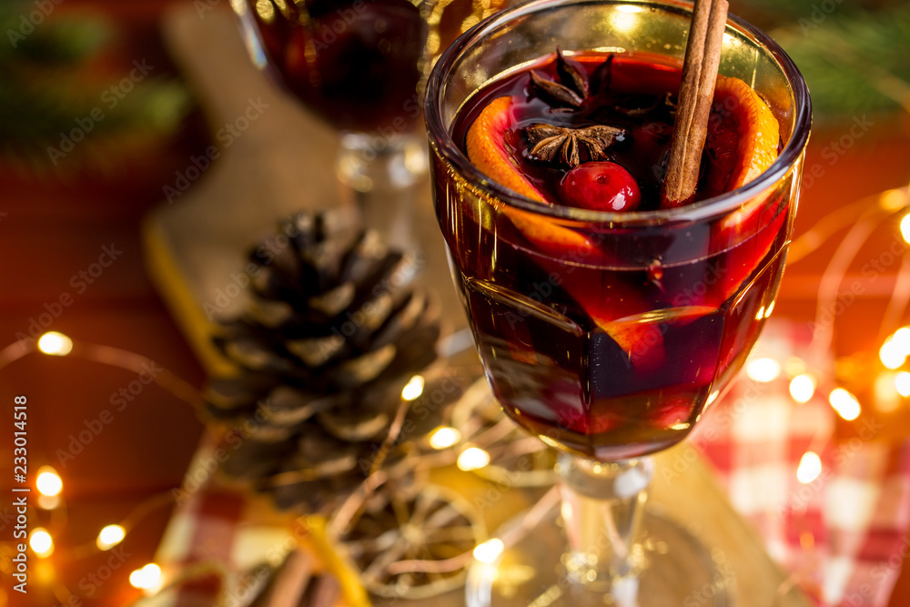 Christmas composition with spicy mulled wine, led lights and pine cones on dark background Christmas composition with spicy mulled wine, led lights and pine cones on dark background