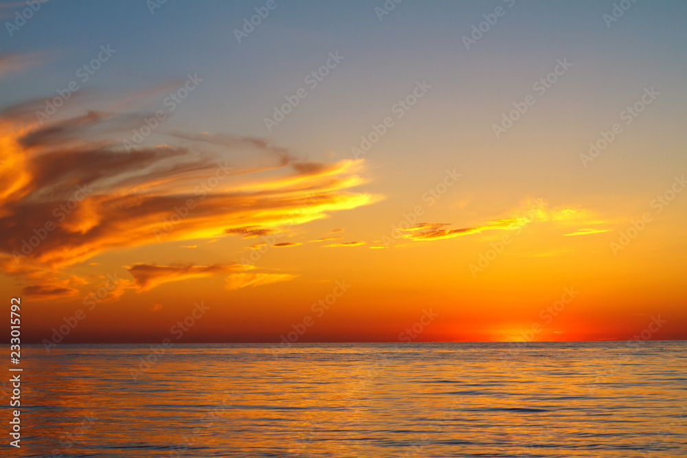 beautiful sunset clouds in the sky over the sea, bright colors of sunset