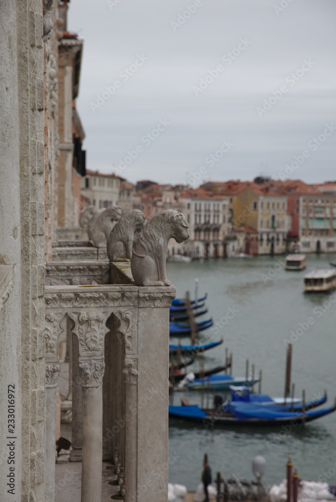 Stone sculptures looking down at Grand Canal in Venice 4968