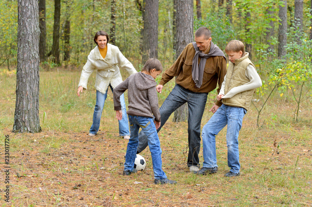 Portrait of big happy family playing football in park