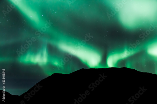 Amazing northern lights in North Norway (Kvaloya), mountains in the background © Kamila Sankiewicz