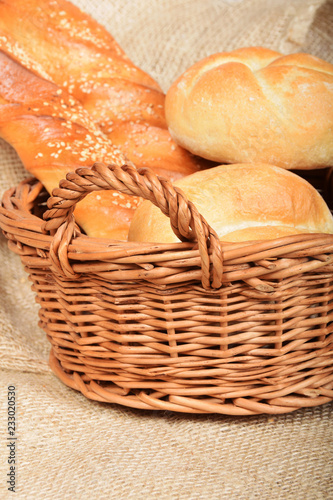 wicker basket with baguettes and bread rolls