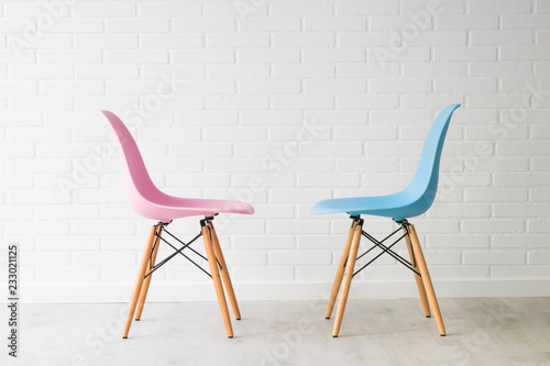 pair of chairs in pink and blue, equality concept photo