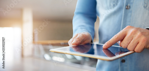 Male hand touching a digital tablet
