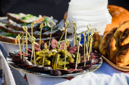 Pickles and canape with blood meat slices on the table. Ukrainian cuisine