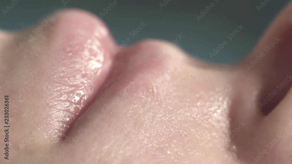 Extremely close-up, painful epilation with sticky wax strips of hair on a female face Extremely close-up, painful epilation with sticky wax strips of hair on a female face