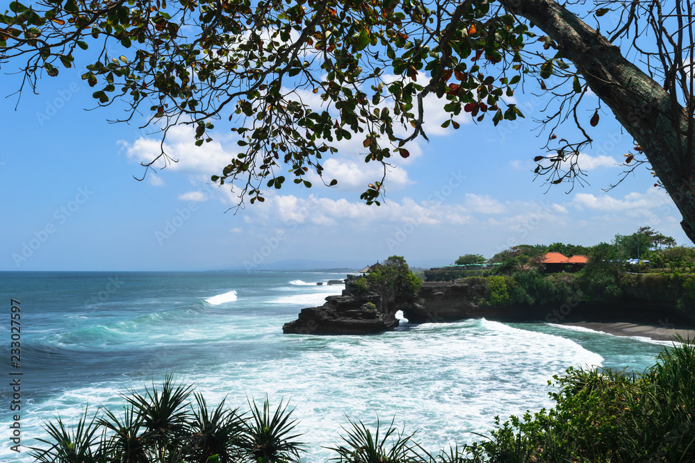 Landscape of Bali island shore with dark blue Indian ocean, huge waves and  black cliff with temple Stock Photo | Adobe Stock