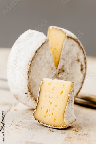 A wheel of Mutschli Swiss cheese, sliced photo