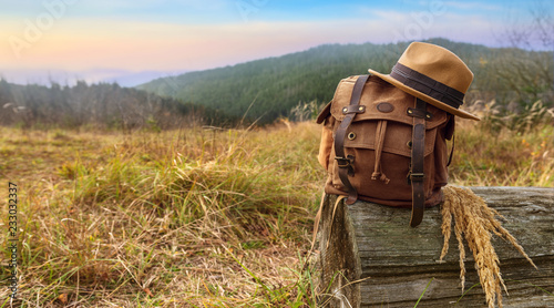 Looking image of traveling concept, backpack and hat . Vacation in mountains.