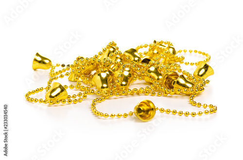 Christmas toys golden beads bells on a white background. Isolation