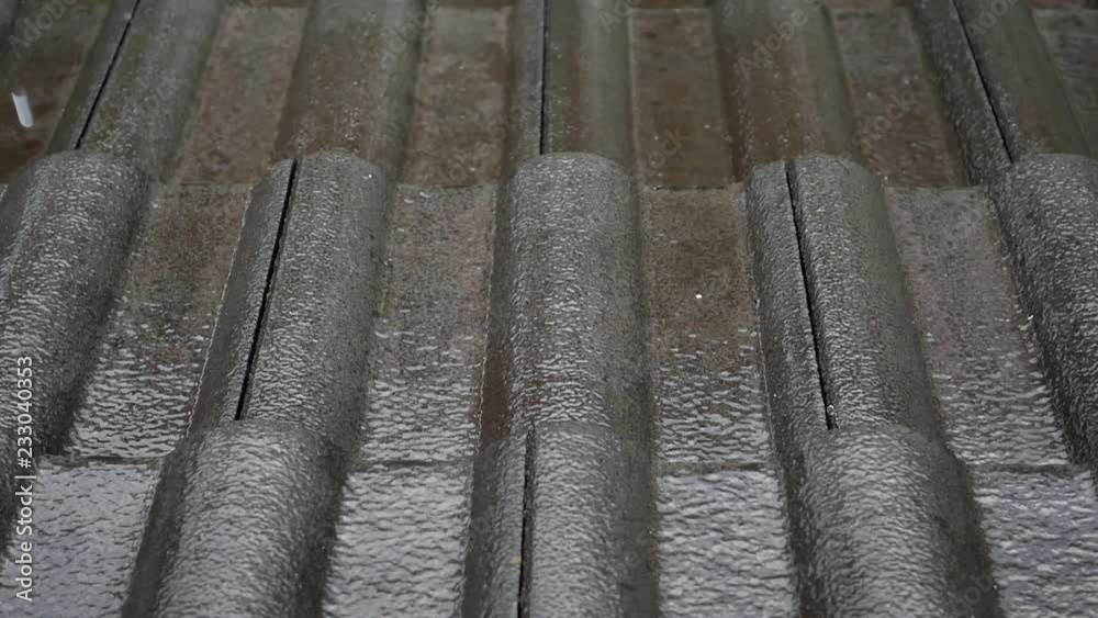slow motion rain drop on roof house