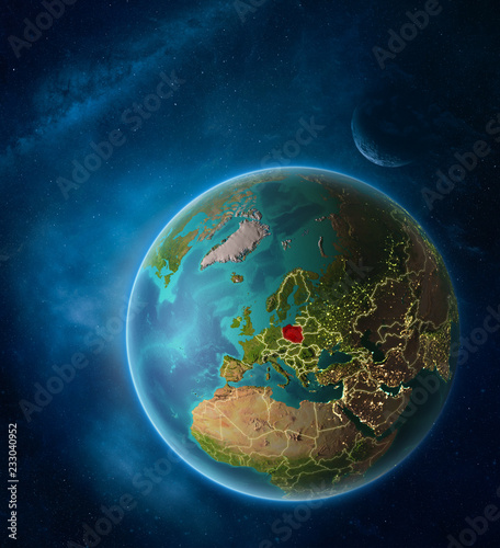Planet Earth with highlighted Poland in space with Moon and Milky Way. Visible city lights and country borders.