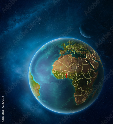 Planet Earth with highlighted Benin in space with Moon and Milky Way. Visible city lights and country borders.