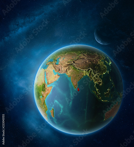 Fototapeta Naklejka Na Ścianę i Meble -  Planet Earth with highlighted Sri Lanka in space with Moon and Milky Way. Visible city lights and country borders.