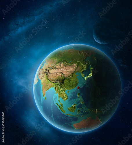 Fototapeta Naklejka Na Ścianę i Meble -  Planet Earth with highlighted Taiwan in space with Moon and Milky Way. Visible city lights and country borders.
