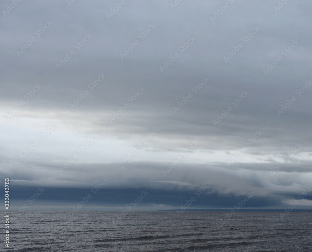 Dark cloud over sea.