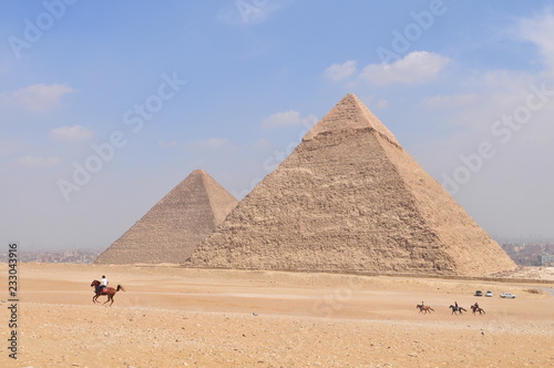 Tourists horseback riding in front of the Pyramids of Giza  Egypt
