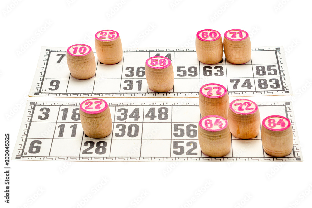 Board game lotto or bingo. Wooden lotto barrels with numbers and cards during a game. Vintage game, isolated on white background.