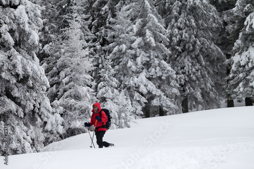 Hiker makes his way on slope with new-fallen snow