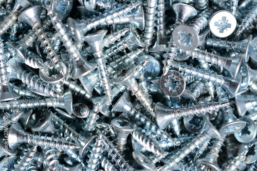 Silver woodscrews macro background, iron screws, steel screw. photo