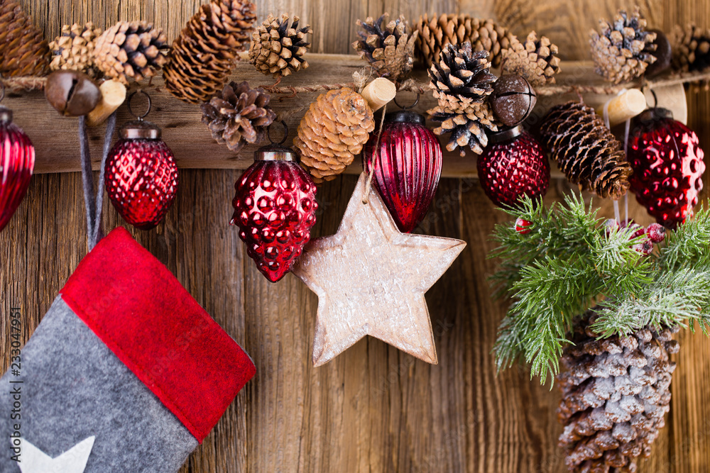 Fototapeta premium Christmas greeting card. Festive decoration on wooden background. New Year concept. Copy space. Flat lay. Top view.