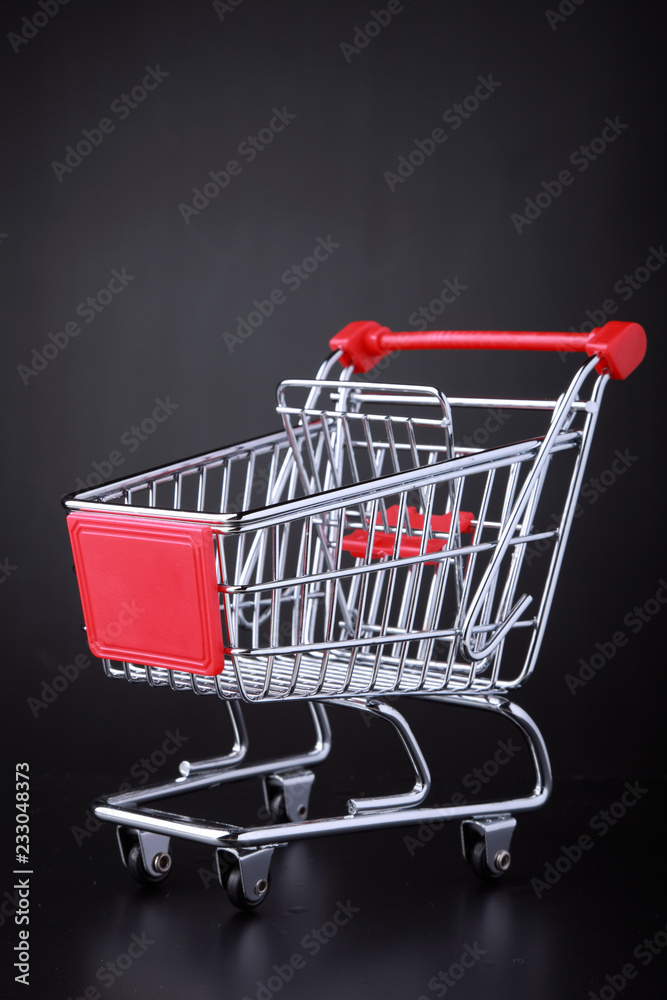 Empty shopping cart in a black background Empty shopping cart in a black background