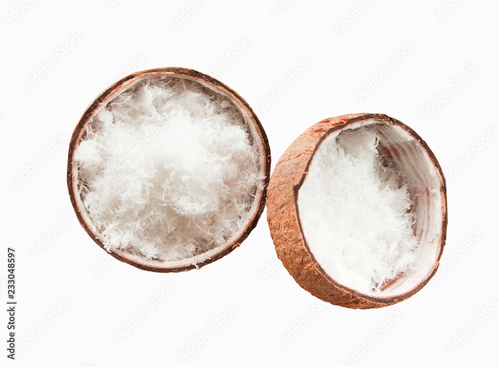 Close up of Freshly grated coconut in shell on wood table.