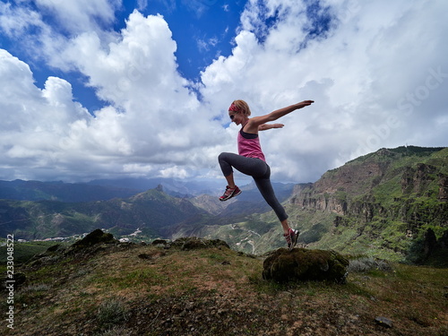 young happy woman jumping on top of the mountain © bereta