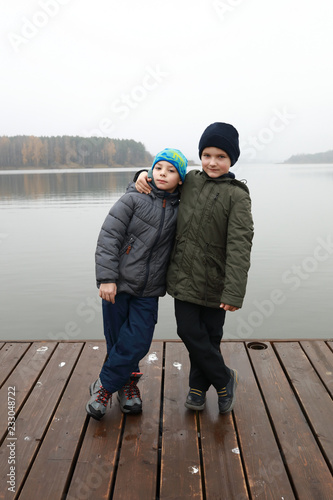 Brothers posing on pier photo