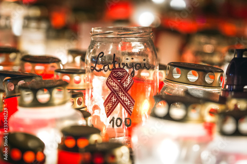 Latvian patriots lighting candles as a tribute to fallen freedom fighters. Hundreds of lighten up candles creating cosy atmosphere. Lāčplēša diena - day of independence of Latvia.  photo