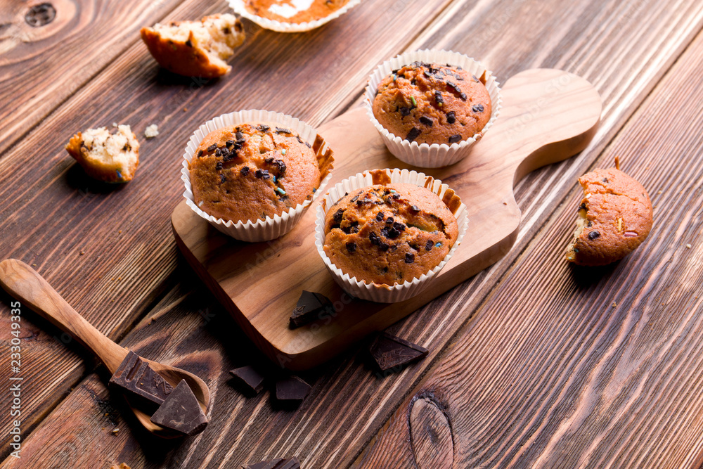 Delicious homemade muffins on wood.