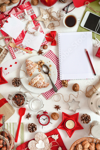 Festive decorations and notebook with wish list on white background. Flat lay style. Top view. Planning concept