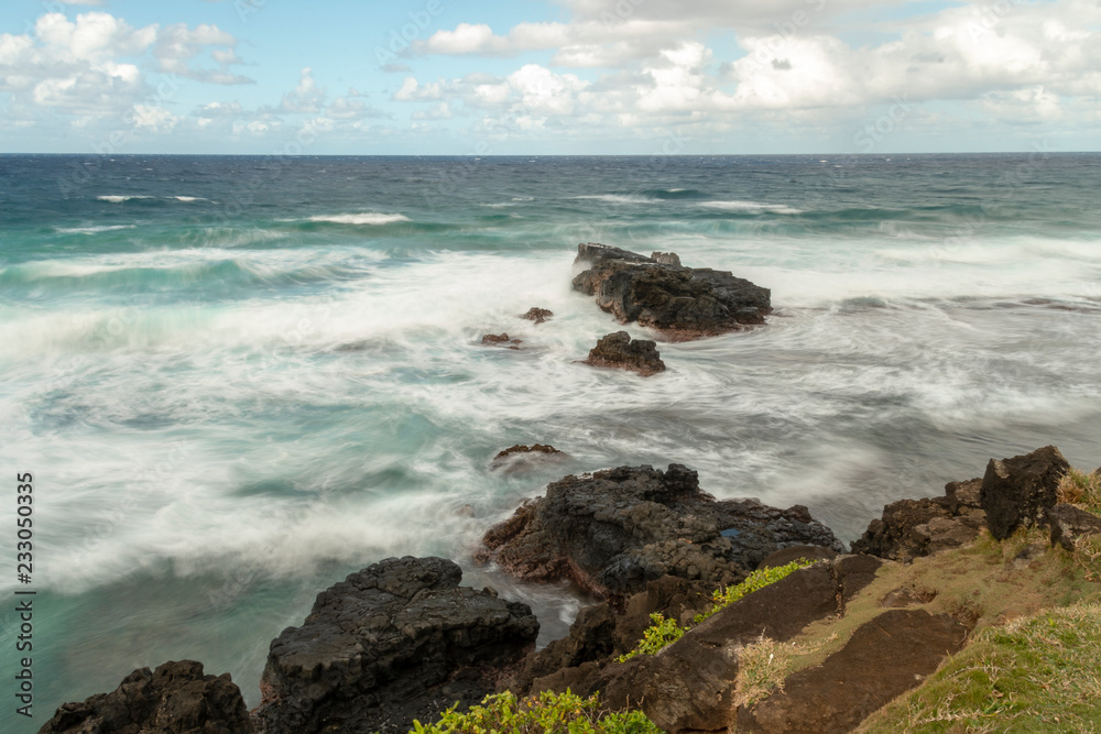 Tropical sea with waves on cliffs - Motion Blur, Soft Focus due to Slow Shutter Speed Tropical sea with waves on cliffs - Motion Blur, Soft Focus due to Slow Shutter Speed
