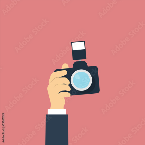 Hand holding photo camera. Flat design style. Vector illustratio