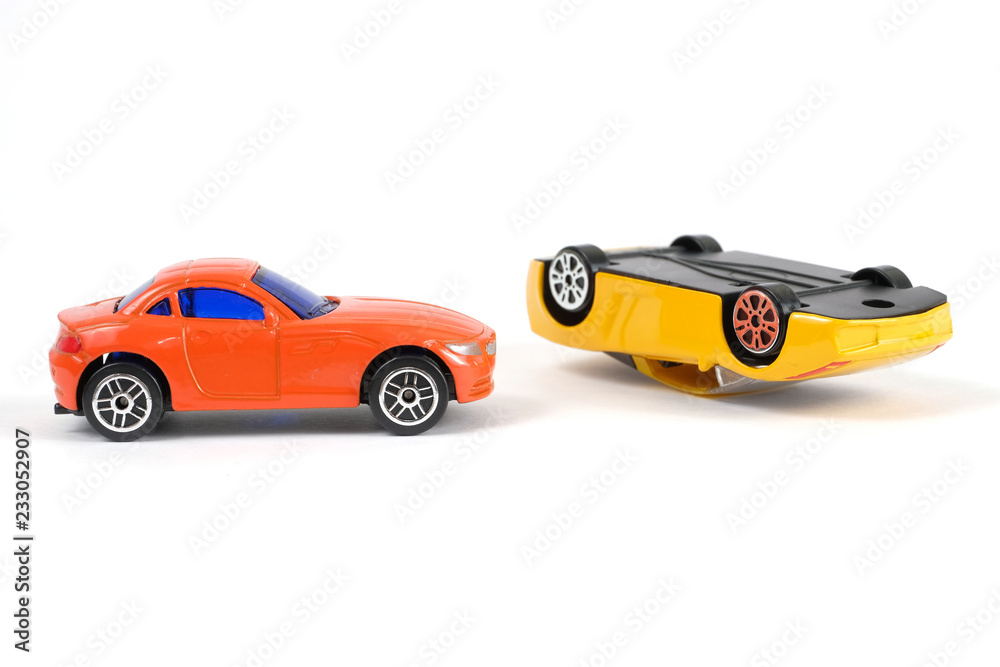 Car accident concept. Yellow and red toy cars on a white background