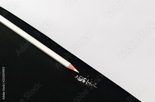 White Pencil With Shaving Isolated on black background. photo