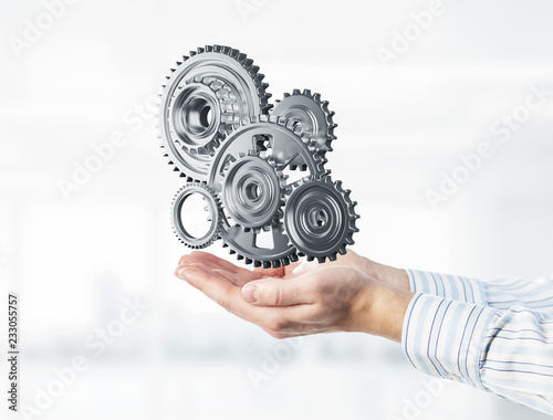 Engine mechanism in male ahnds as symbol for cooperation or team