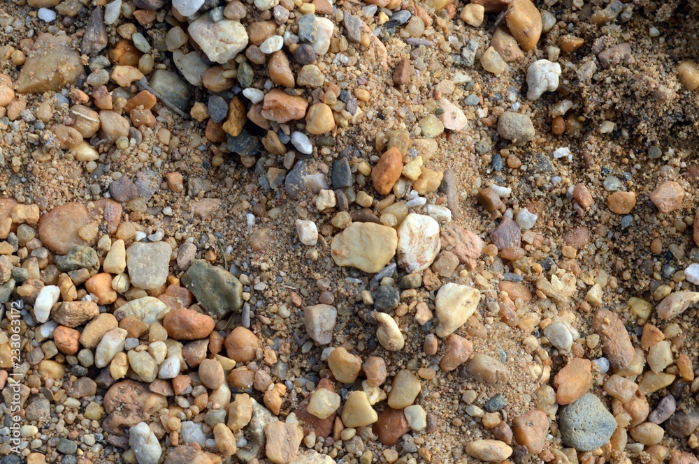 Stones as background, light brown to red and gray to white texture and sand