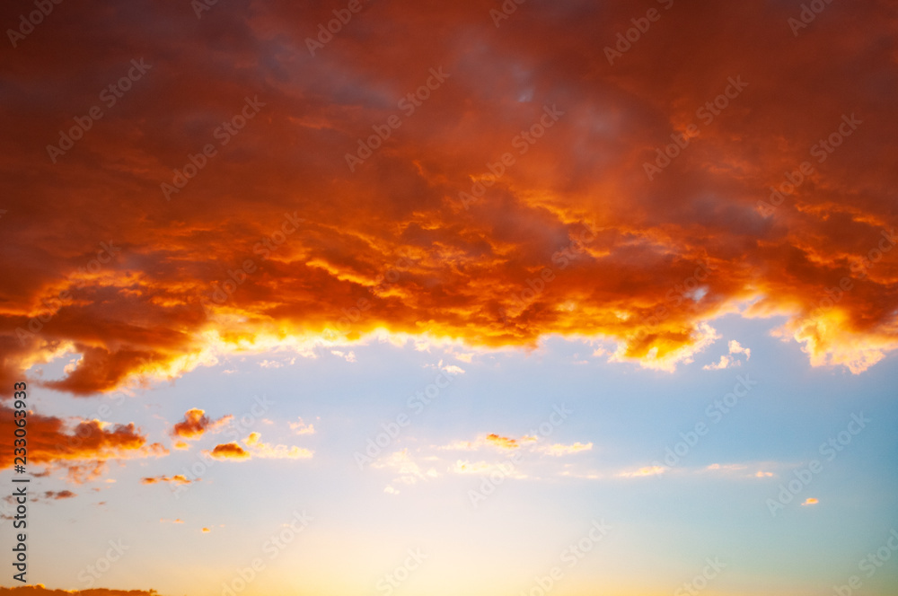 Clouds in a red colored sunset in the Colorado Desert Plateau at the Tuba City, United States. It is the spectacle of nature - the first hints of rose that creep into the sky and turn into a blaze
