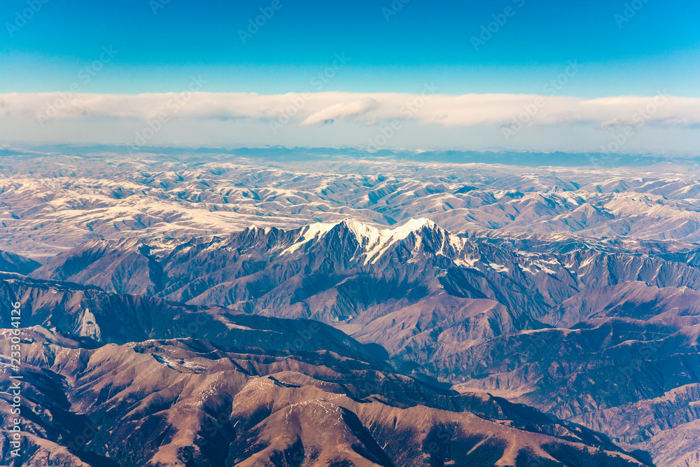 view from the aircraft to the mountains of the Himalaya on Chinese Tibetan side snow