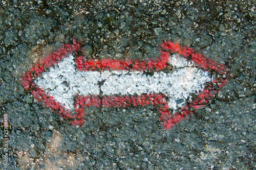Arrows on the asphalt for the orientation of the walker while walking along the path photo
