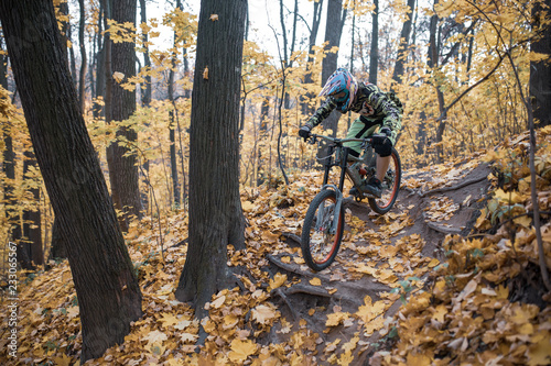 Photo of athlete in helmet riding sports bike on track