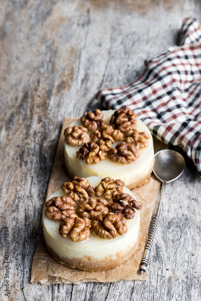 Two mini walnut cheesecake on wooden table Two mini walnut cheesecake on wooden table