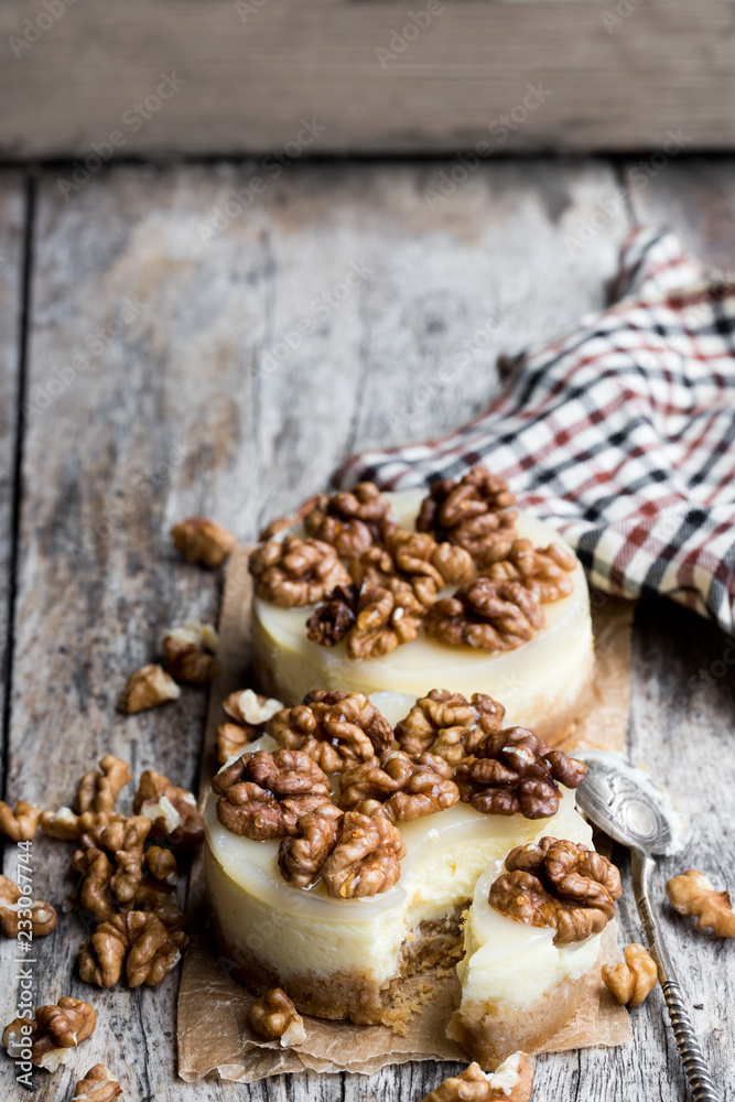 Fototapeta premium Two mini walnut cheesecake on wooden table