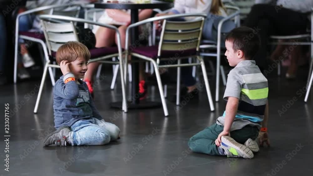 Two funny friends boy play sitting in a cafe smile feel happy party child cute restaurant caucasian family glass kid delicious innocence indoor close up Two funny friends boy play sitting in a cafe smile feel happy party child cute restaurant caucasian family glass kid delicious innocence indoor close up