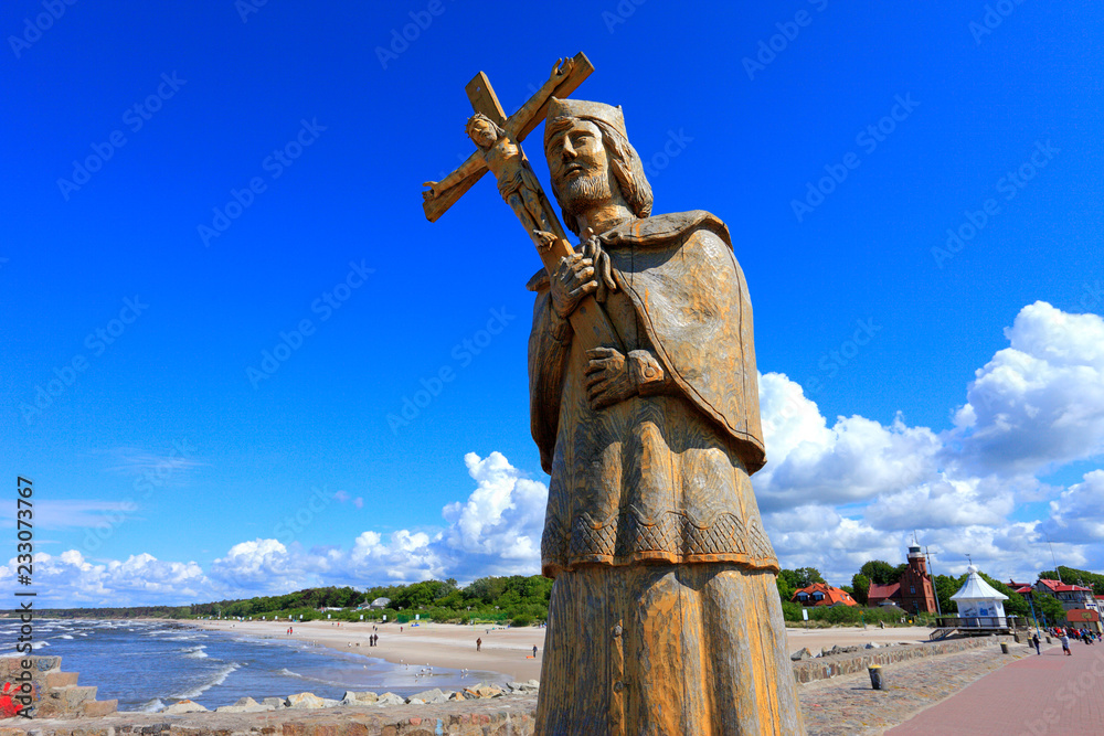 Fototapeta premium Ustka, Pomerania, Poland - Statue of Saint John of Nepomuk at the breakwater constructions at the Slupia river confluence into Baltic Sea